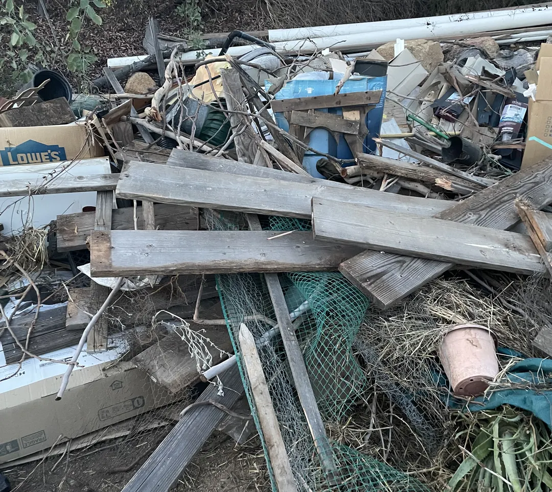 Pile of old lumber, fencing and yard debris cleared from a property
